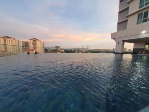 a pool of water in front of a building at De Centrum By Jom La Homestay, Kajang Bangi in Kajang