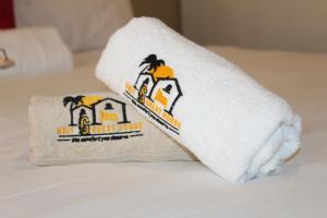 two towels sitting on top of a bed at Unit G Guest House in Ga-Mothiba
