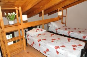 a bedroom with two bunk beds with flowers on them at Ca'Rino in Bene Vagienna +25 photos