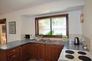 a kitchen with a sink and a counter top at Palm Waters 4 - Wi-Fi & Linen Included in Inverloch