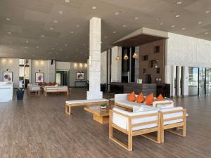 a lobby with couches and tables in a building at Serin Tagaytay Staycation in Tagaytay