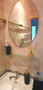 a bathroom with a sink and a mirror at Krymo g. Lovely 2 room flat in Šiauliai, near Akropolis in Šiauliai