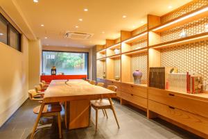 a dining room with a wooden table and chairs at Gion Misen in Kyoto