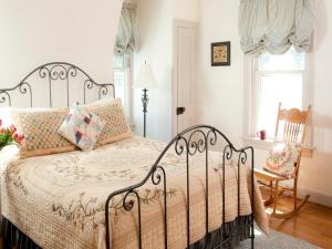 a bedroom with a bed and a chair and a window at Brickhouse Inn B&B in Gettysburg