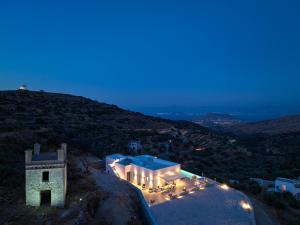 a building on the side of a hill at night at Villa Luxury Magic View in Lefkes