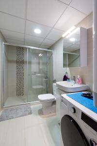 a bathroom with a shower and a toilet and a sink at Gric Apartments in Ohrid
