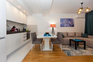 a kitchen and living room with a couch and a table at Gric Apartments in Ohrid