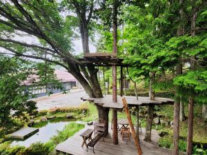 a tree house with benches in a park at みんなの家ポレポレ in Urugi +65 photos