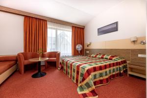 a hotel room with a bed and a window at Info Hotel in Palanga