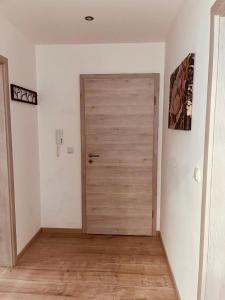 a door in a room with a wooden floor at Ferienwohnung Elfi in Kirchdorf im Wald