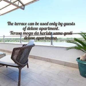 a chair sitting on a balcony with a quote at Villa Tower Gardos in Belgrade