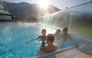 a group of people in a swimming pool at Alpen-Chalet-Pankraz in Fügenberg