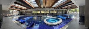 a large swimming pool in a building at Free SPA в Св. Иван Рилски - Сладък дом сред лукс in Bansko