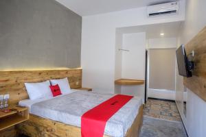 a bedroom with a bed and a television in it at RedDoorz @ Klaten City in Klaten
