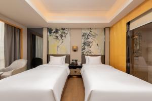 Postel nebo postele na pokoji v ubytování Zhuhai Longzhuda International Hotel
