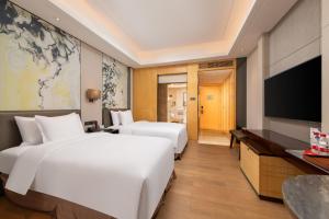 TV a/nebo společenská místnost v ubytování Zhuhai Longzhuda International Hotel