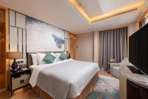 TV a/nebo společenská místnost v ubytování Zhuhai Longzhuda International Hotel