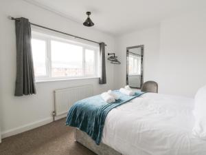 a bedroom with a large bed with towels on it at Butter Cross in Scarborough