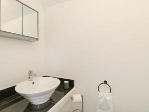 a bathroom with a white sink and a mirror at Butter Cross in Scarborough +24 photos