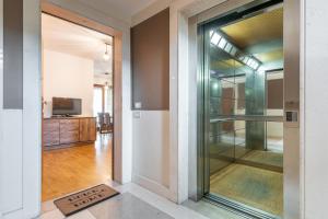 a glass door leading into a hallway with a television at Casa Paola in Cagliari +23 photos
