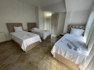 a bedroom with two beds with towels on them at Hotel Montenegro in Struga