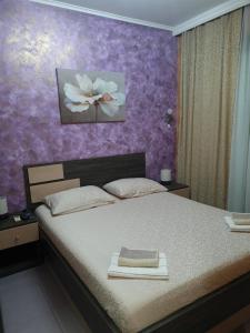 a bedroom with a bed with a book on it at Apartman Centar Lux in Budva