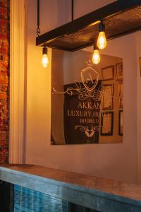 a mirror at a restaurant with a sign on the wall at Akkan Hotel in Bodrum City