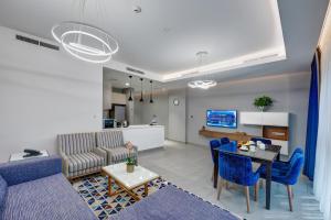 a living room with a couch and a table at ABAR HOTEL APARTMENTS DIP-1 in Dubai