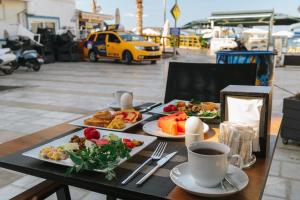 a table with plates of food and a cup of coffee at Akkan Hotel in Bodrum City