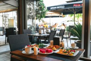 a table with two plates of food on it at Akkan Hotel in Bodrum City