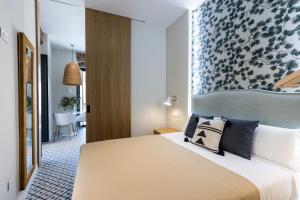 Posteľ alebo postele v izbe v ubytovaní Apartamentos El Patio, Plaza Mayor Trujillo
