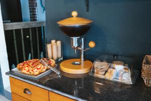 a counter with a food mixer and a plate of food at Akkan Hotel in Bodrum City