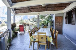 an outdoor patio with a table and chairs at Vétiver in Cilaos