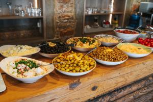 a buffet with bowls of food on a table at Akkan Hotel in Bodrum City
