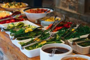 a table topped with plates of vegetables and dips at Akkan Hotel in Bodrum City