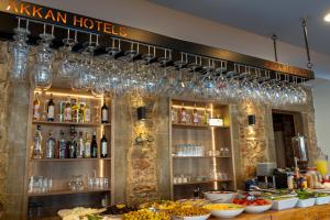 a bar with wine glasses and food on a counter at Akkan Hotel in Bodrum City