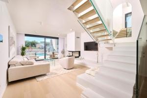 ein Wohnzimmer mit weißen Treppen und einem Sofa in der Unterkunft Villa Pura Vida in Materada