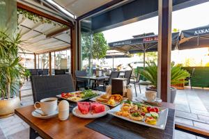 a table with three plates of food on it at Akkan Hotel in Bodrum City