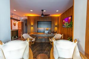 a living room with chairs and a table and a kitchen at Akkan Hotel in Bodrum City