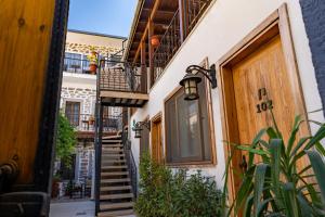 a narrow alley with stairs and a balcony at Akkan Hotel in Bodrum City