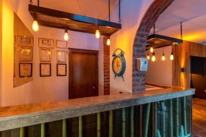 a bar in a restaurant with a clock on the wall at Akkan Hotel in Bodrum City