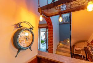 a clock hanging on the wall of a house at Akkan Hotel in Bodrum City