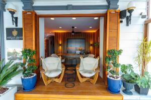 a porch with two chairs and a table at Akkan Hotel in Bodrum City