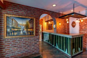 a brick wall with a painting on the wall at Akkan Hotel in Bodrum City