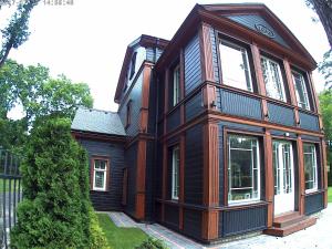 a house with a clock on the side of it at Exquisite 1930's Historical House in Jūrmala