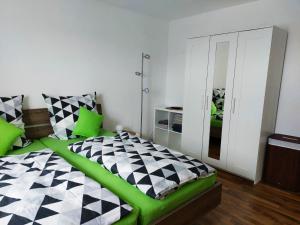 a bedroom with a black and white bed with green accents at Haus Kramer in Bad Bellingen