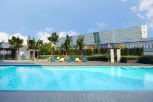 a large swimming pool in front of a building at The Quarter Ladprao by UHG in Bangkok