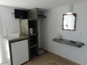 a kitchen with a small refrigerator and a shelf at Studio farma in Zefiría