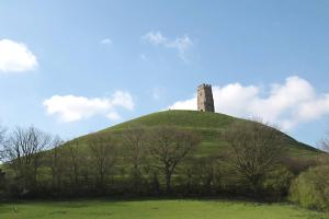 a grassy hill with a tower on top of it at No 28D St Benedict in Glastonbury