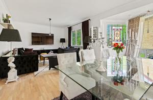 a living room with a glass table and chairs at Beautiful Home in the Swedish landscape in Vissefjärda